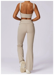 Back view of high-impact beige yoga sports bra and high-waisted flared leggings set