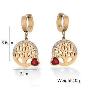 Detail view of 18K gold tree of life earrings with red heart gem and size markings