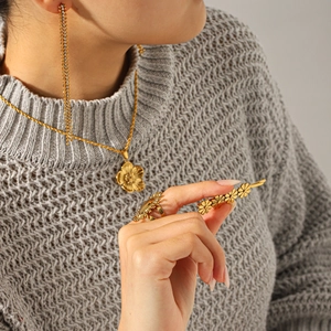 Golden flower jewelry set with crystal necklace, tassel earrings, ring, and hair clip