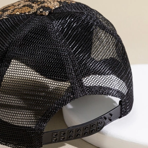 Detail of black mesh trucker hat with adjustable plastic strap and golden sequins
