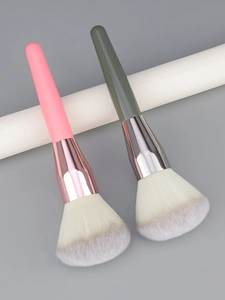 Detail view of large powder brushes with soft fiber bristles and colorful matte handles