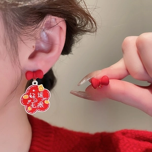 Detail of red earrings with pearl studs featuring Good Luck and Wealth Chinese script