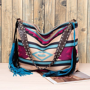 Detail view of Bohemian woven tote with intricate geometric patterns and long tassel charms