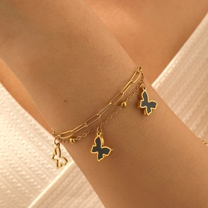 Double-layer stainless steel bracelet featuring black and hollow gold butterfly pendants