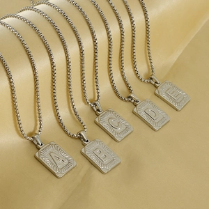 Classic square titanium steel alphabet necklaces with A-E pendants on champagne satin