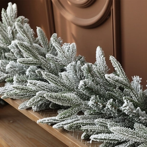 Realistic green PE Christmas garland with dense white flocking snow effect for winter decor