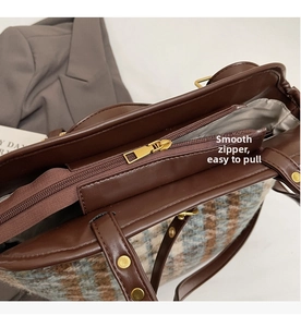 Close-up of smooth gold zipper on large capacity retro plaid tote bag for commute