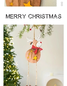 Detail of wooden Christmas reindeer ornament with scarf hanging on a pine tree branch