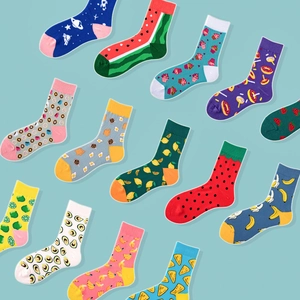 Flat lay collection of colorful cotton crew socks featuring fruit and art patterns