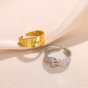 Detailed close-up of adjustable mushroom rings with floral engravings in gold and silver