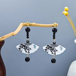 Detailed close-up of Chinese fan earrings with bamboo ink painting and black beads