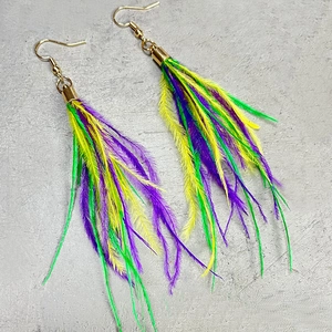 Detail of glitter feather metal mesh earrings in vibrant green, purple, and yellow tones