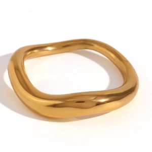 Polished 18K gold plated stainless steel irregular wavy ring on a white background