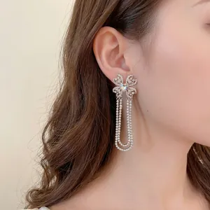 Silver bow pearl tassel earrings with pink heart gemstone and sparkling rhinestones