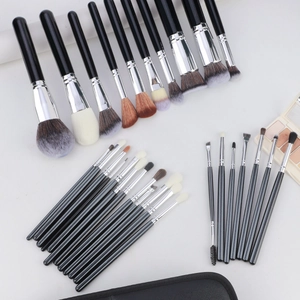Detailed overhead view of 30 professional makeup brushes with silver ferrules and black handles