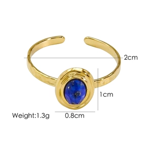 Detail view of gold hammer textured ring with blue gemstone and dimension measurements