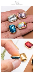 Macro detail of faceted rectangular gemstone charms with gold-plated metal frames