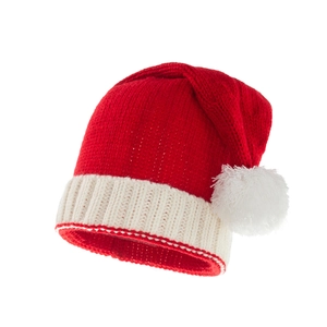 Macro detail of red knitted Christmas hat with a fluffy white pompom and ribbed brim