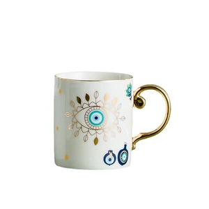 Nordic ceramic coffee mug with gold-rimmed evil eye pattern and elegant curved handle