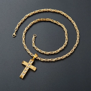 Nahaufnahme einer goldenen Byzantiner-Kette mit funkelndem Zirkonia-Kreuzanhänger