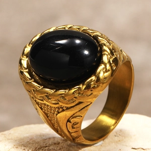Macro detail of men's vintage steel ring with black oval gemstone and braided texture