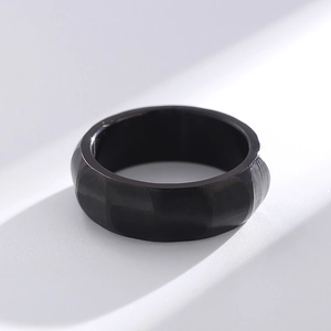 Macro view of matte black faceted titanium steel ring with unique geometric texture design