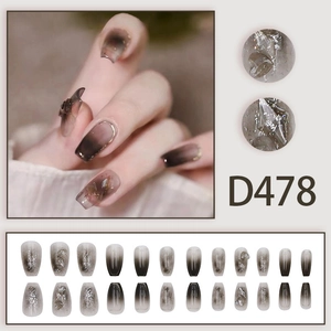 Detail of grey gradient press-on nails with glitter and 3D crystal accents in ballet shape