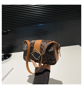 Detail of leopard print shoulder bag featuring gold diamond clasp and brown faux leather strap
