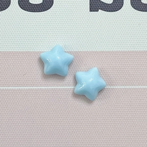Close-up of light blue star-shaped resin charms for DIY jewelry and phone case making