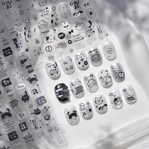 Detail of 3D embossed nail stickers featuring black and white graffiti cats and notes