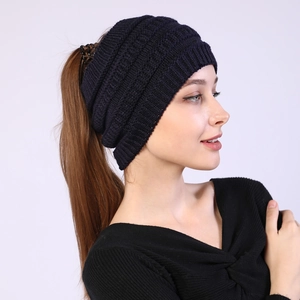 Detail showing navy blue knit headband texture and functional ponytail hole design