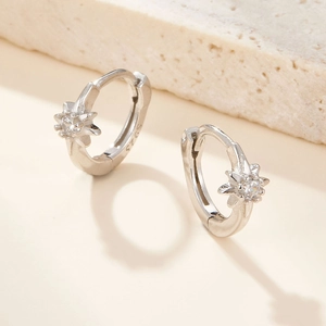 Macro shot of S925 sterling silver hoop earrings with star-shaped cubic zirconia detail