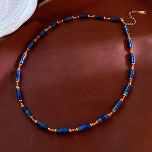 Detail of bohemian natural stone necklace with lapis lazuli and amber beads