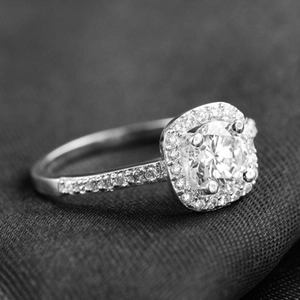 Macro shot of silver S925 sterling silver halo ring with a brilliant round center stone