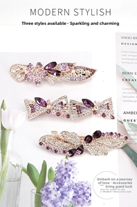 Close-up of gold alloy hair clips with purple and pink rhinestone flower details