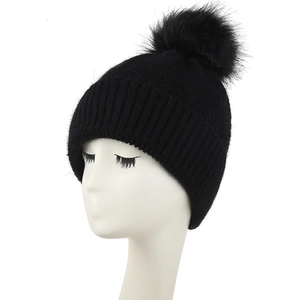 Women's black knit winter beanie with thick fleece lining and faux fur pom-pom detail