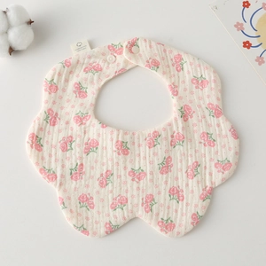 Detail of floral cotton muslin baby bib with petal shape and soft breathable texture