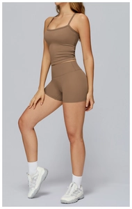 Detail of coffee brown brushed yoga tank top and high-waist shorts set in studio light