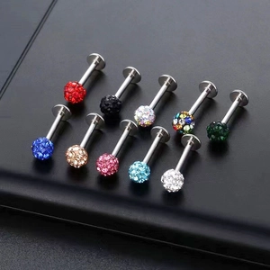 Macro shot of colorful disco ball labret studs and piercing jewelry in various shades