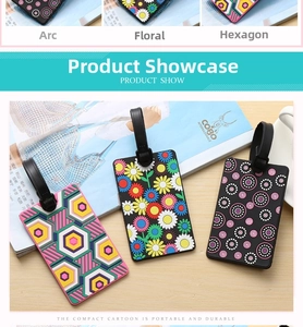 Three patterned PVC luggage tags with floral and geometric designs on a light wooden background
