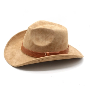 Detail of light camel suede cowboy hat featuring brown leather band and metal studs