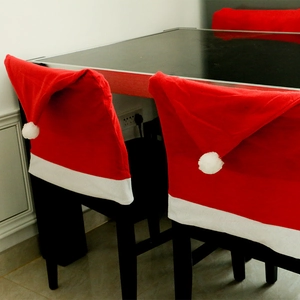 Set of red and white Santa hat chair covers for festive Christmas home dining decoration