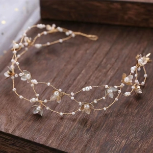 Detailed macro view of bridal hair vine with white pearls and gold floral beads