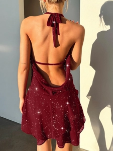 Detail of elegant dark red halter neck dress with backless design and sequin finish
