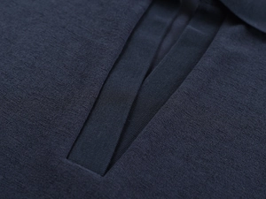 Detailed macro view of dark blue waffle knit fabric and polo collar stitching texture