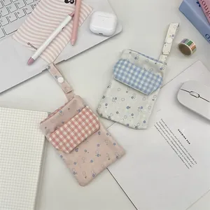 Close-up of floral canvas nurse pocket protectors in pink and blue with checkered flaps