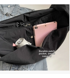 Interior view of black nylon crossbody bag showing spacious main compartment and pockets
