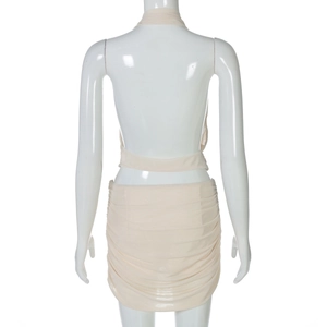 Back view of beige halter cutout mini dress with ruching detail on professional model