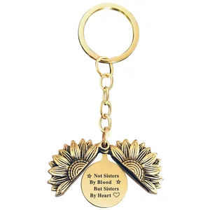 Detail of engraved sunflower keychain with friendship quote Not Sisters By Blood