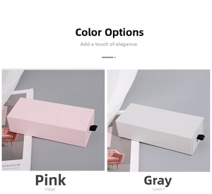 Pink and gray drawer gift boxes with black ribbon pulls and textured surface finish